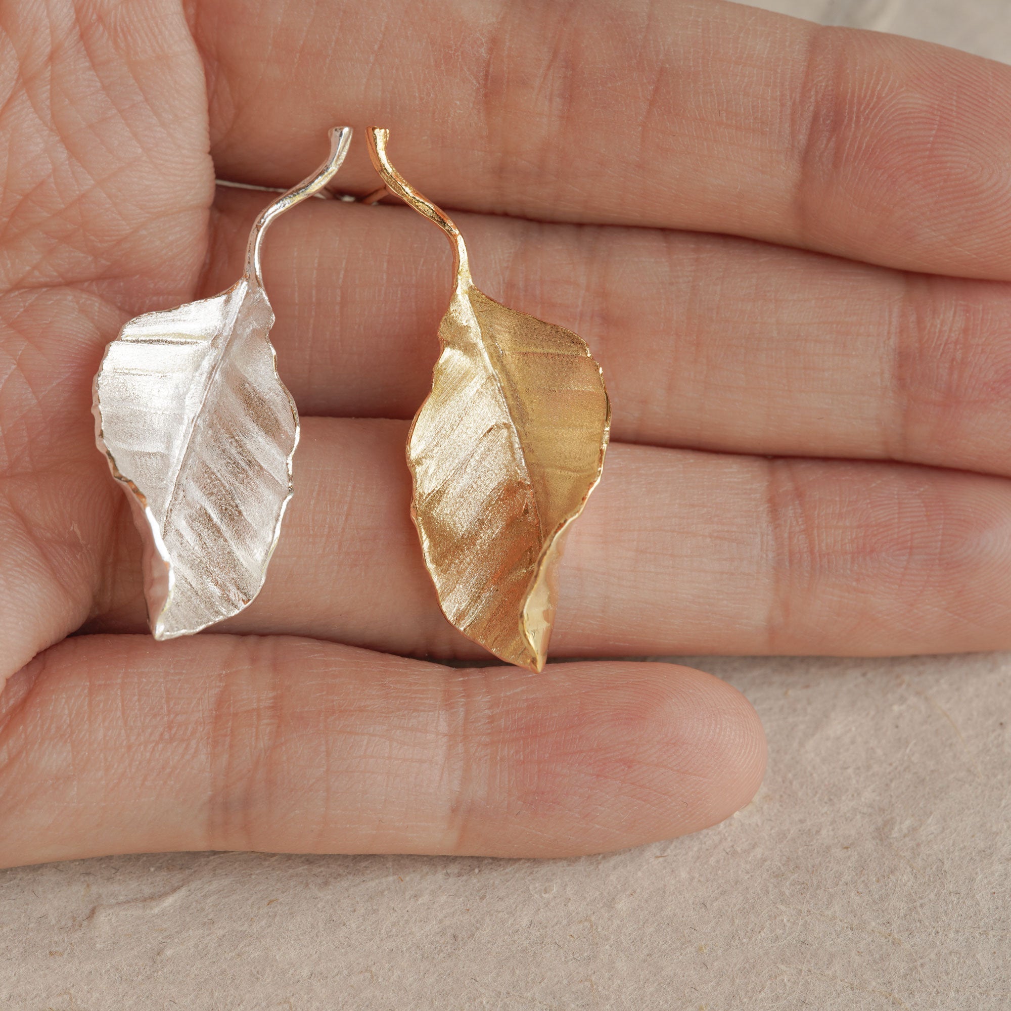 Leaf drop earrings displayed as a pair