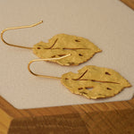 Leaf earrings showing handmade jewelry details