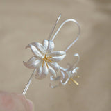 Lily drop earrings on a neutral product background