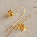 Magnolia earrings displayed as a pair