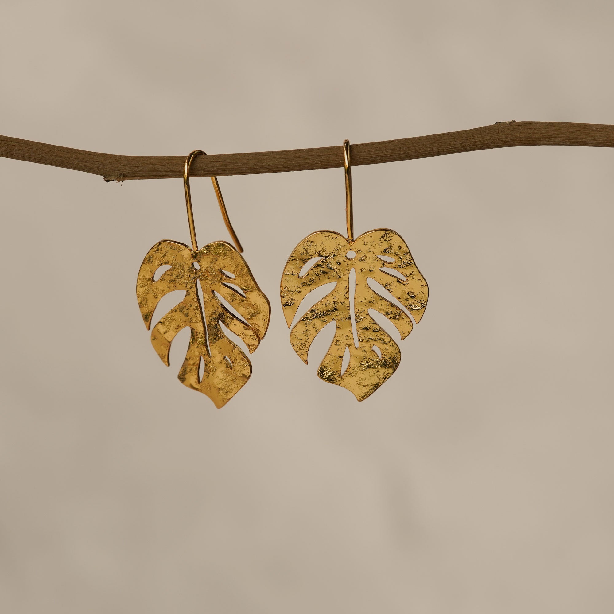 Monstera leaf earrings showing handmade details
