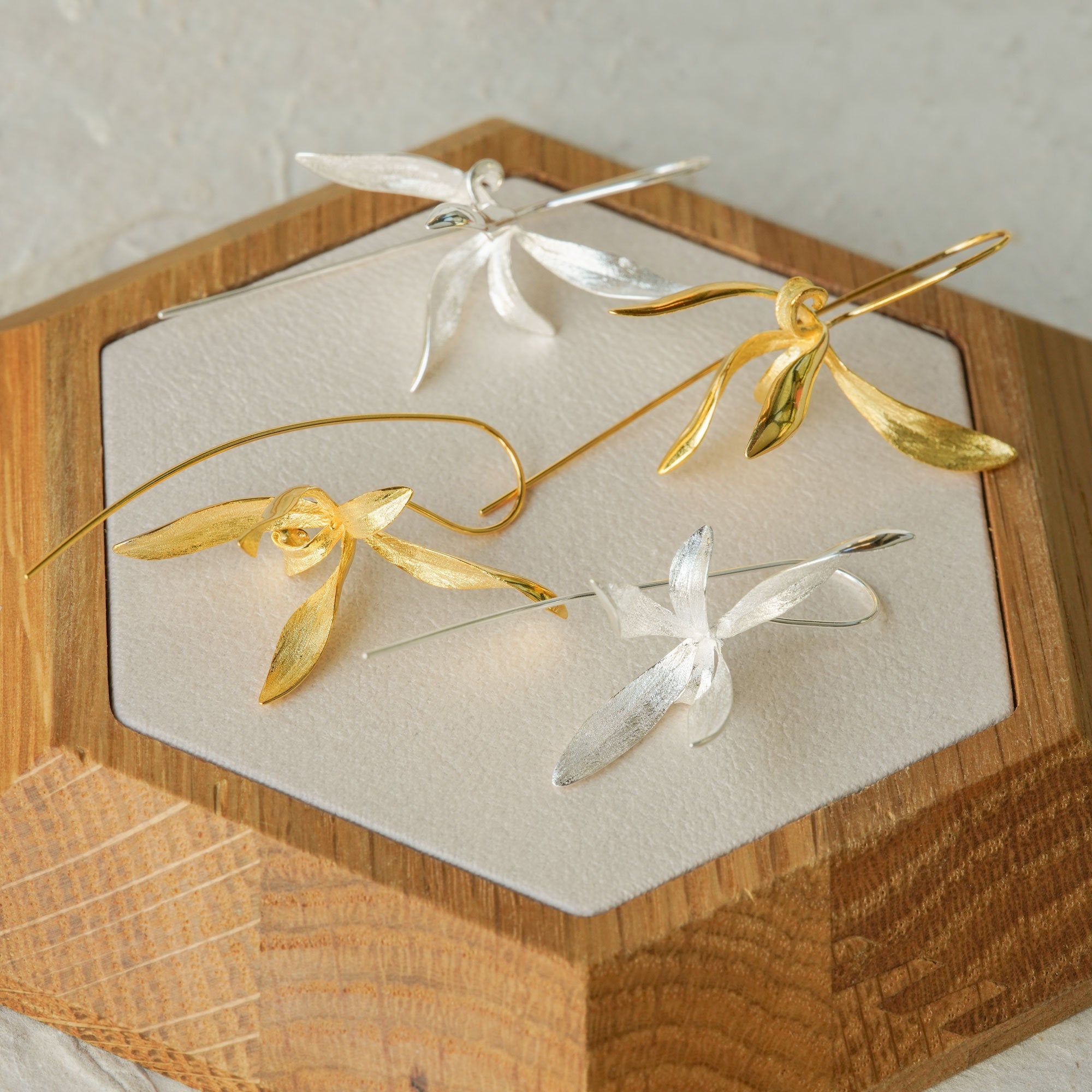 Orchid earrings on neutral product background