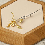 Orchid flower brooch displayed as botanical jewelry