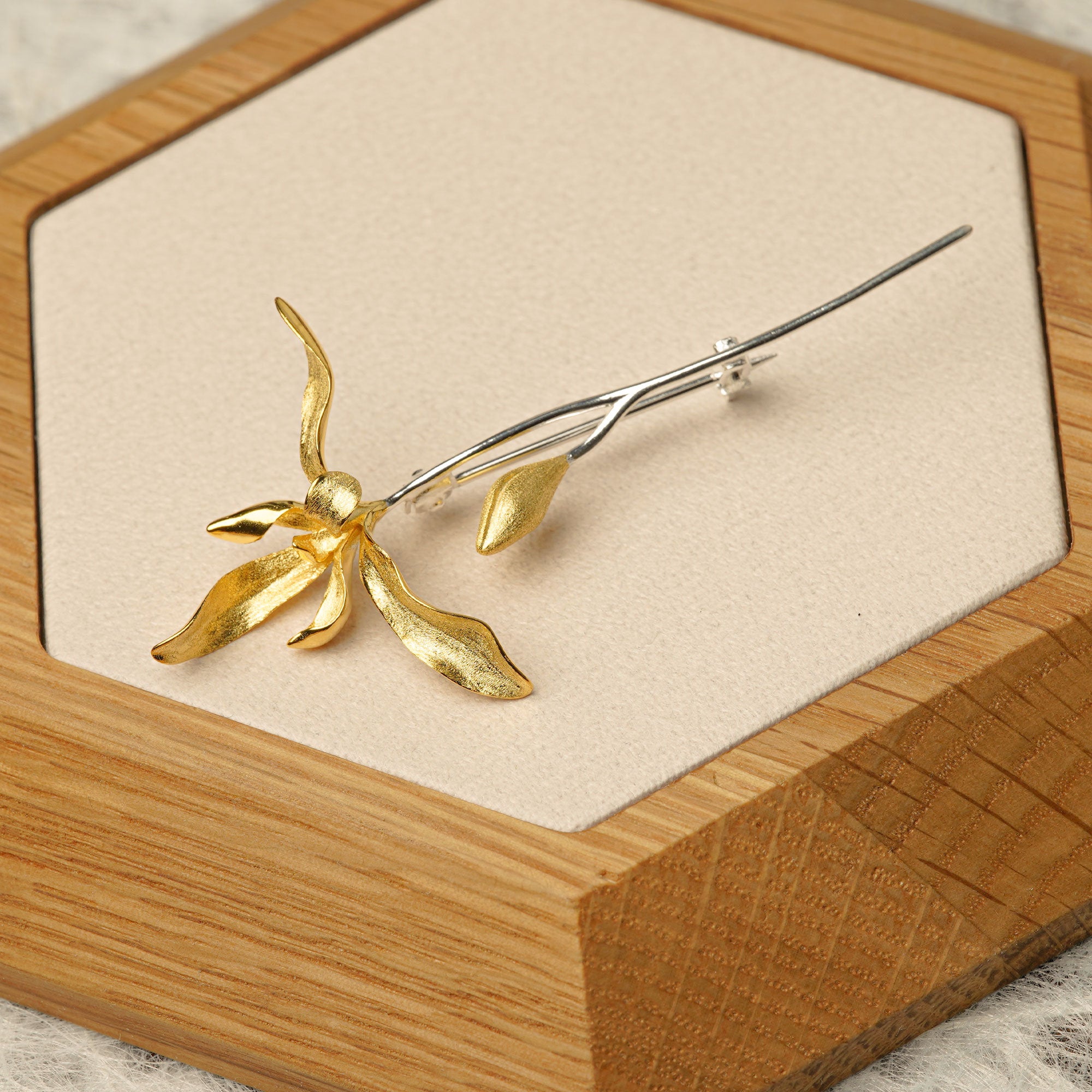 Orchid flower brooch displayed as botanical jewelry