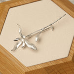 Side view of orchid flower brooch pin