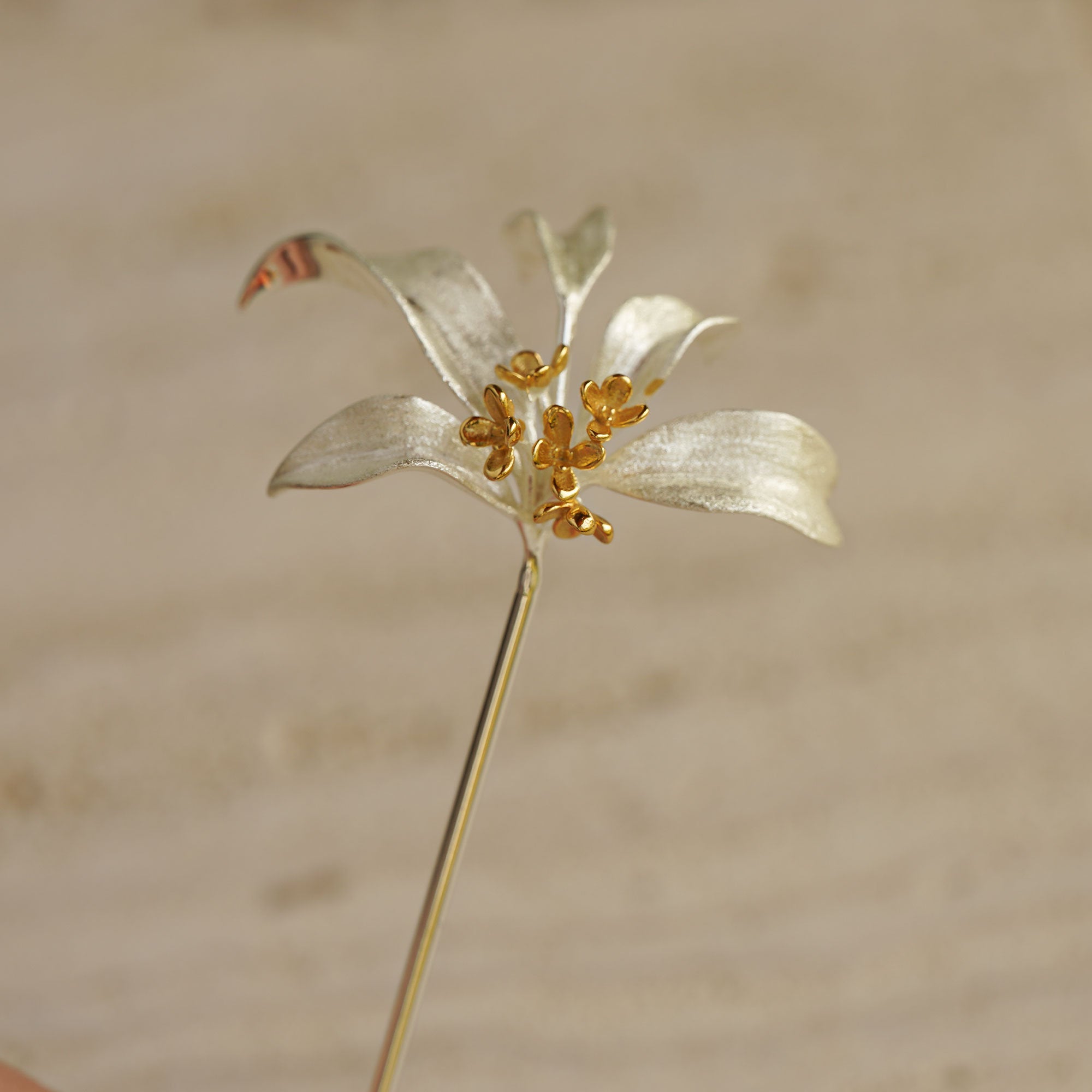 Osmanthus brooch displayed as botanical pin jewelry