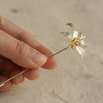 Osmanthus flower brooch on neutral product background