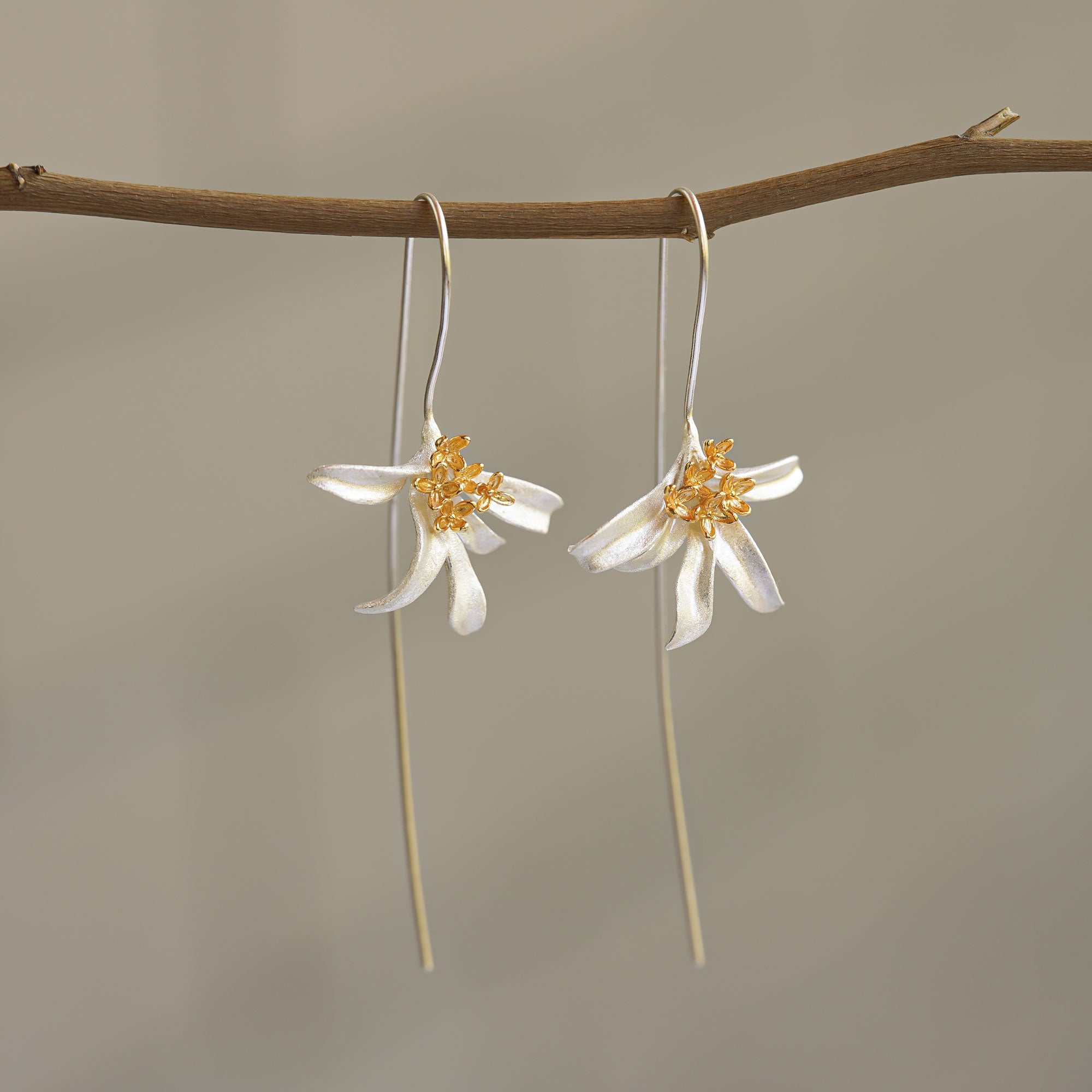 Osmanthus flower earrings displayed as botanical jewelry