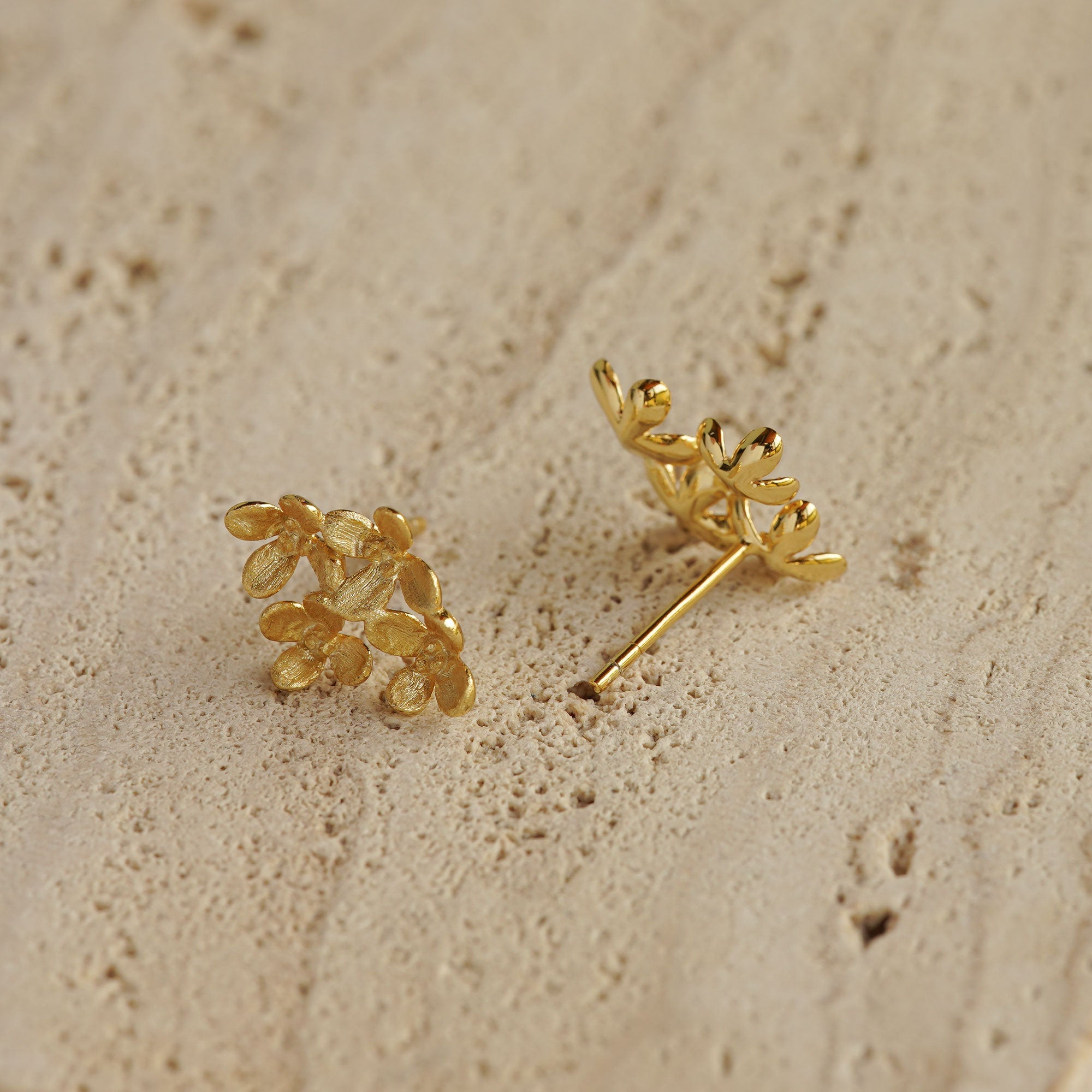 Osmanthus flower earrings displayed as a pair