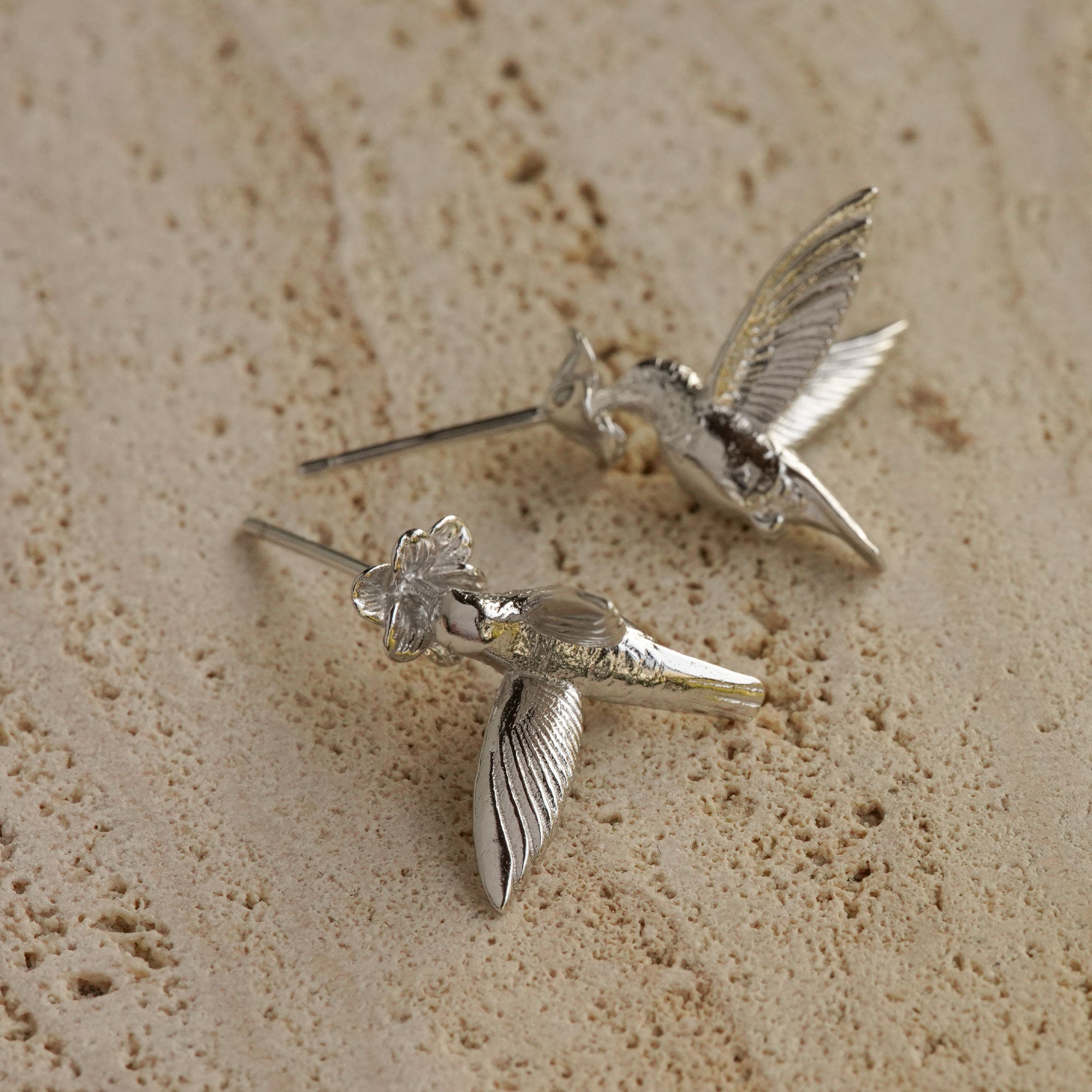 Pair of hummingbird earrings displayed together