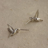 A pair of silver hummingbird earrings