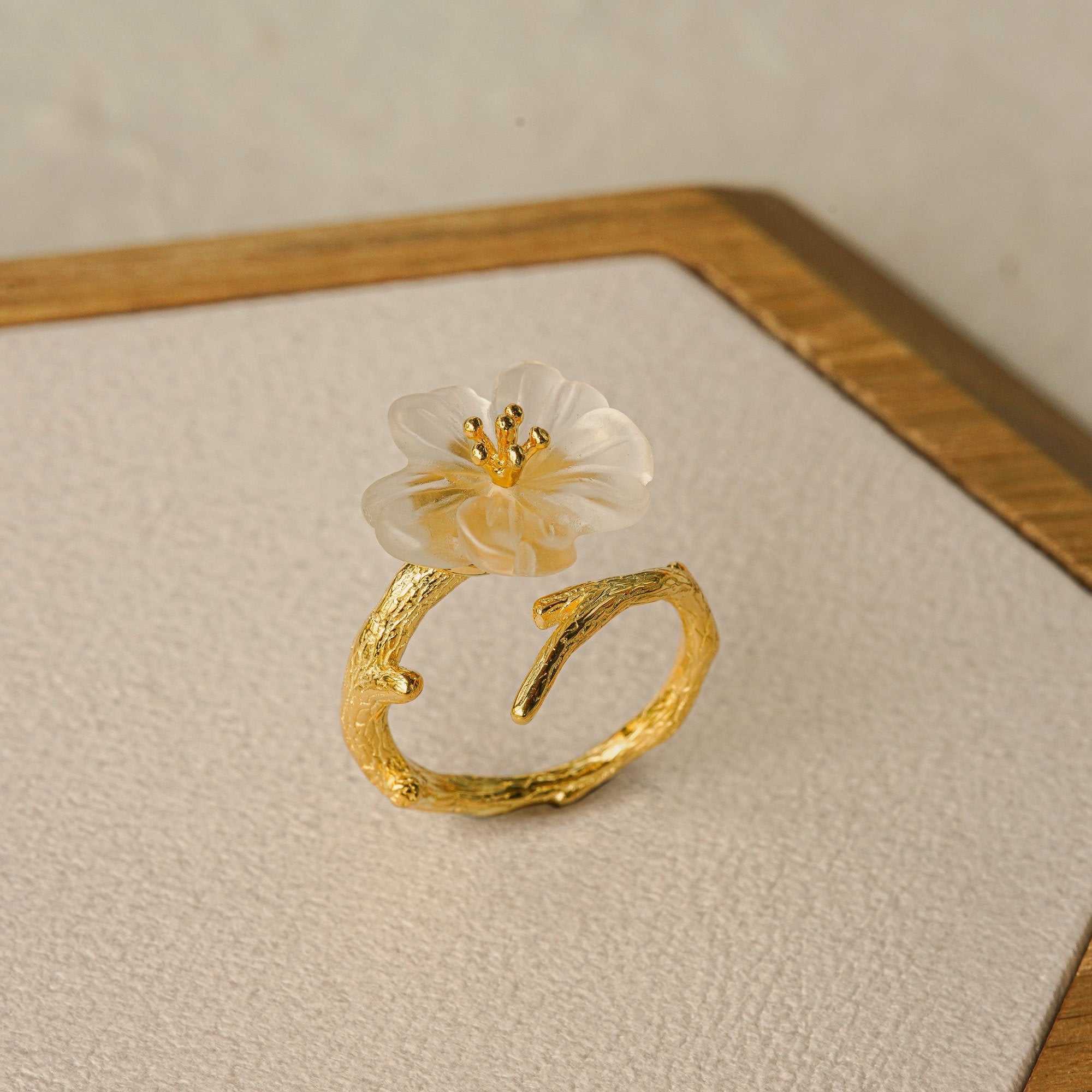 Pear blossom ring displayed on neutral background