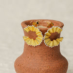 Pencil earrings on a neutral product background