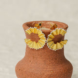 Pencil earrings on a neutral product background