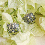 Pixiu earrings on a neutral product background