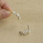 Plum blossom earrings styled as botanical jewelry