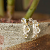 Plum blossom earrings showing handmade jewelry details