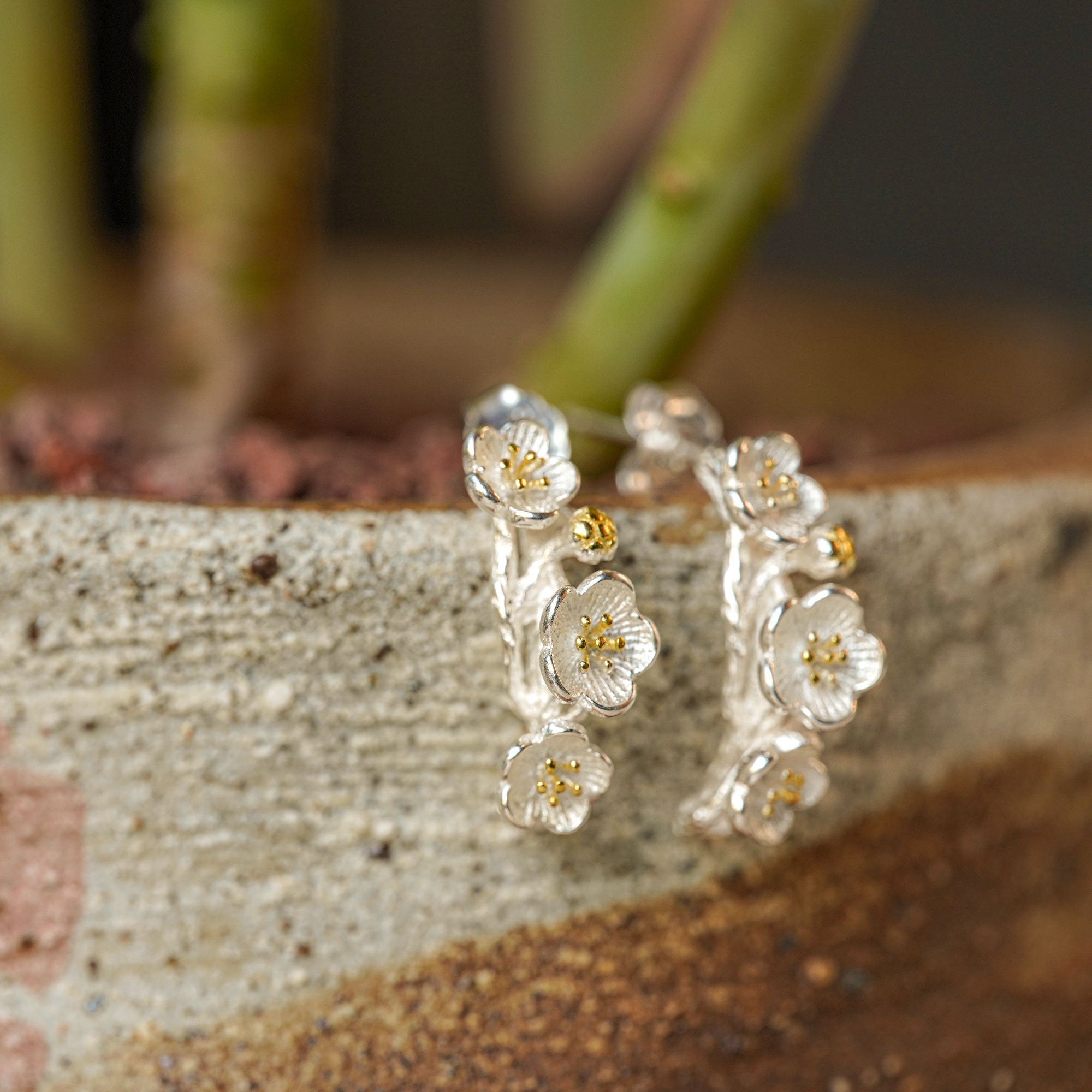 Plum blossom earrings showing handmade jewelry details