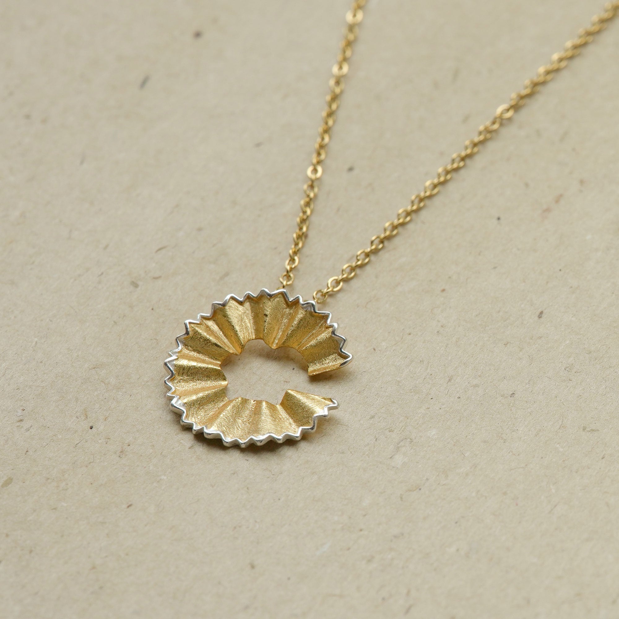 Side view of art pencil necklace pendant