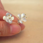 Side view of crab apple flower earrings