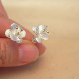 Side view of crab apple flower earrings
