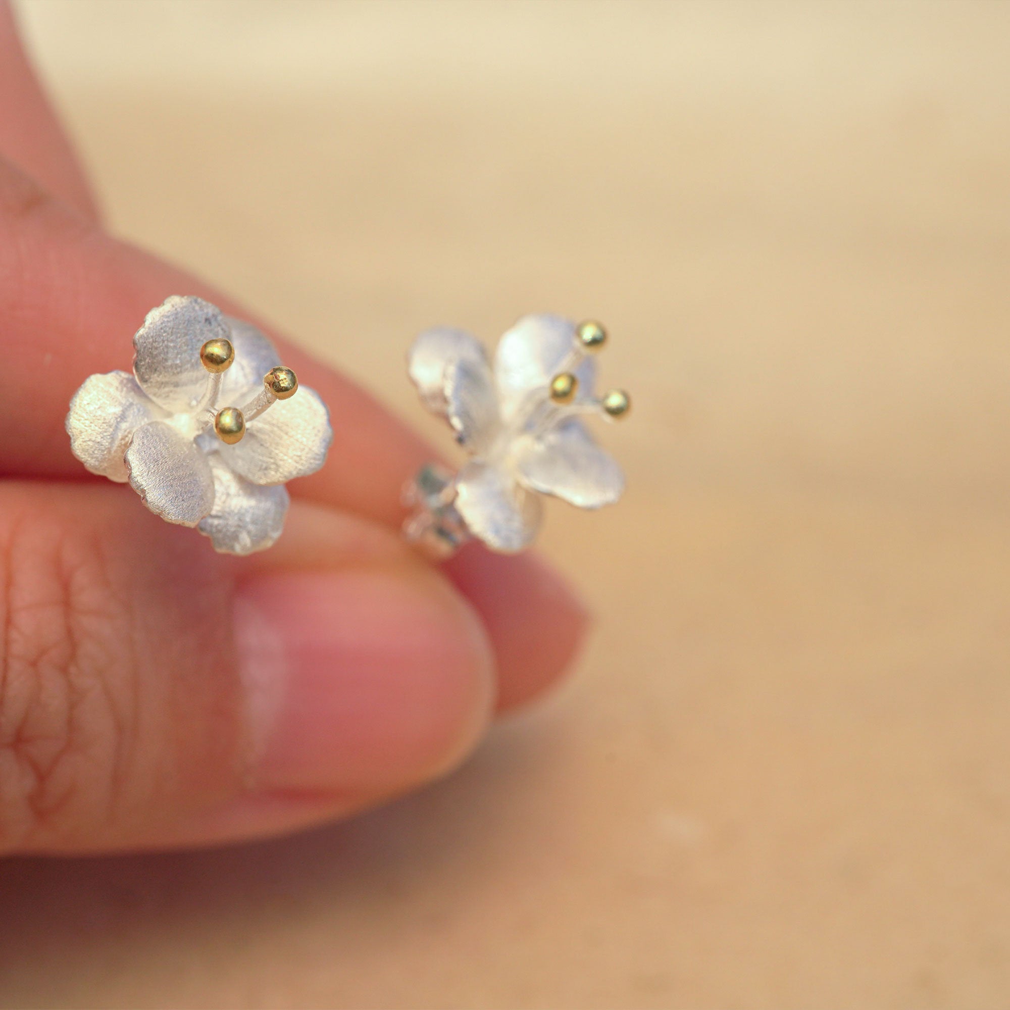 Side view of crab apple flower earrings