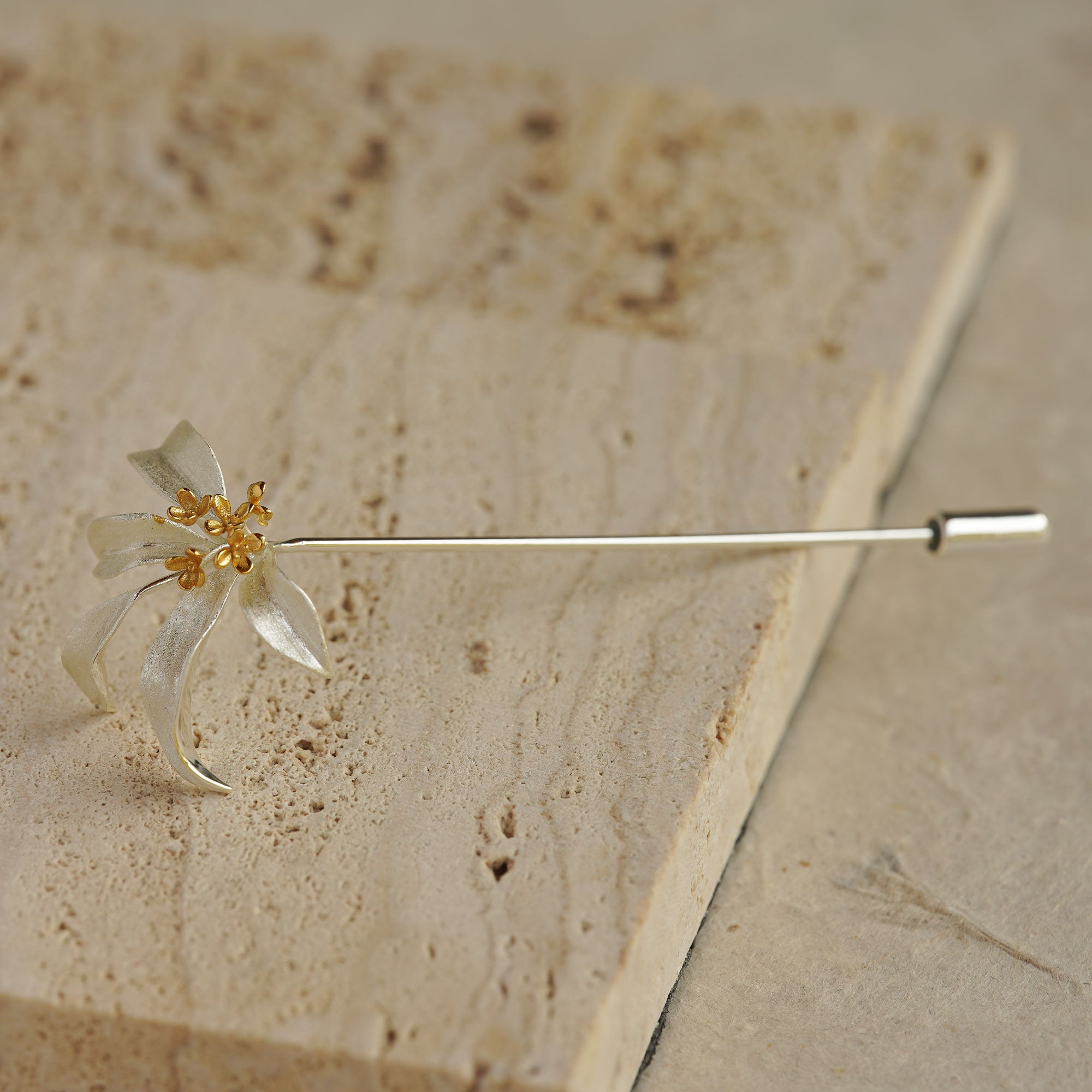 Side view of osmanthus flower brooch