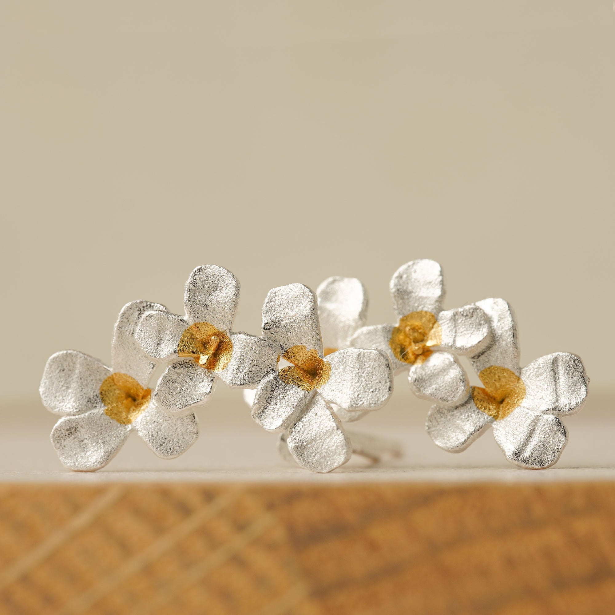 Silver flower earrings showing handmade jewelry details