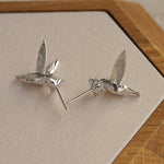 Silver hummingbird earrings with bird silhouette design