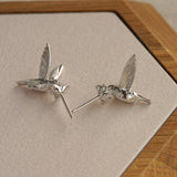 Silver hummingbird earrings with bird silhouette design