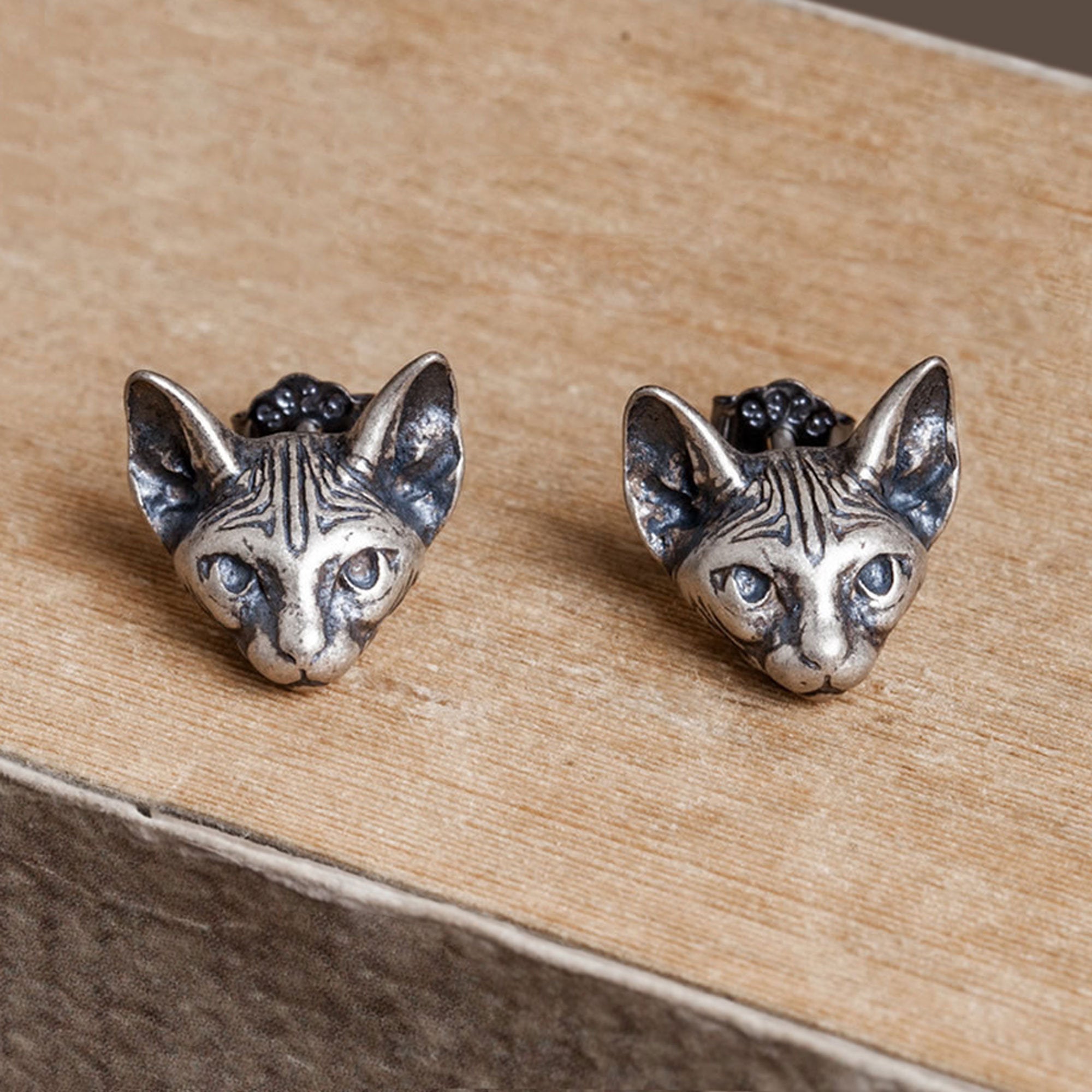 Sphinx cat earrings showing handmade jewelry details