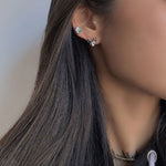 Sphinx cat earrings on a neutral product background