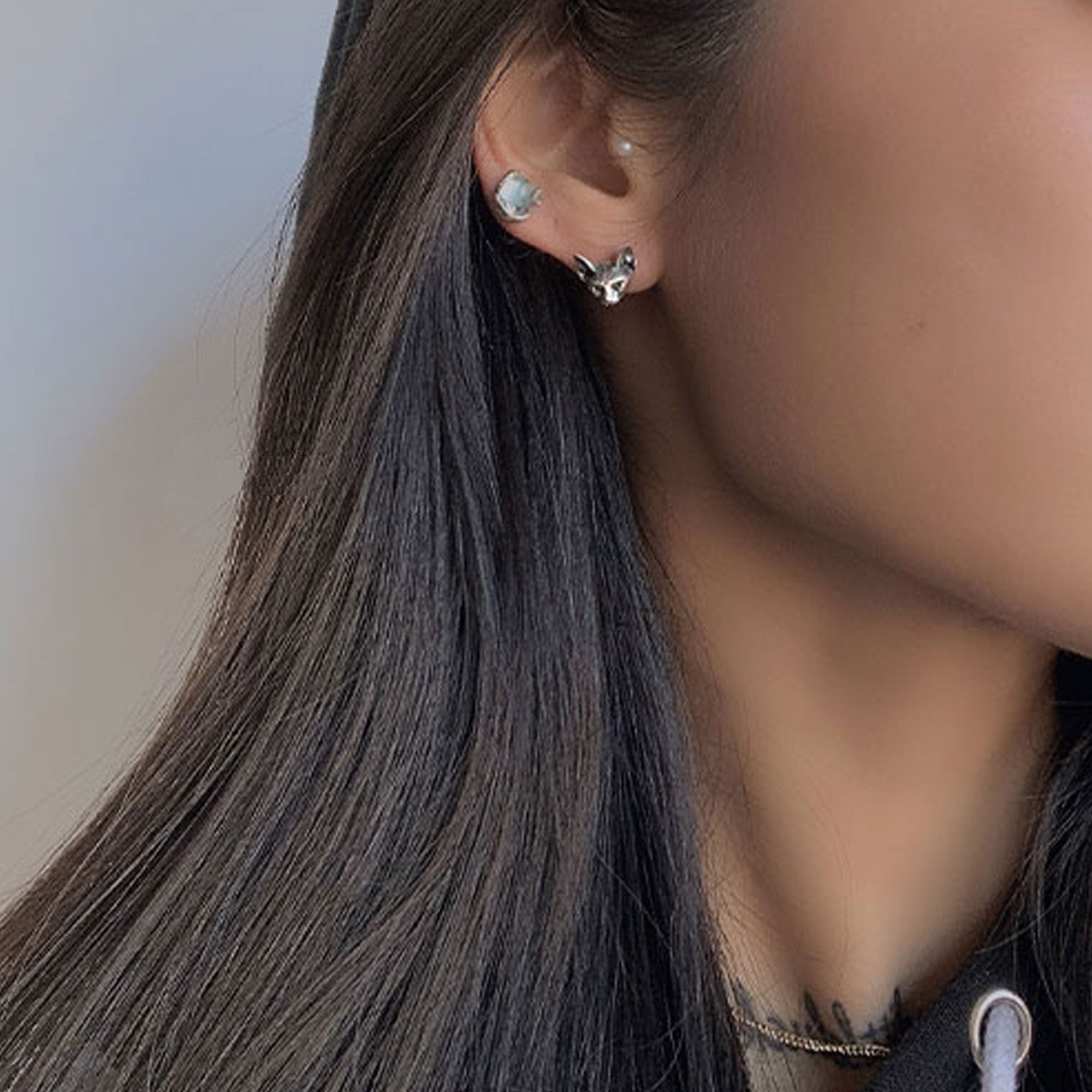 Sphinx cat earrings on a neutral product background