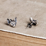 Sphinx cat earrings displayed as a pair